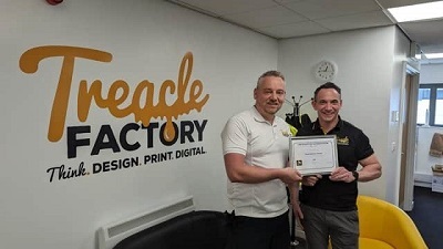 Treacle Factory employees holding award