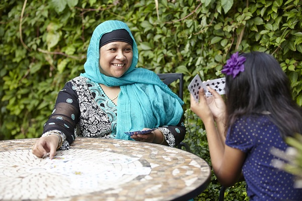 Muslim mum child playing cards