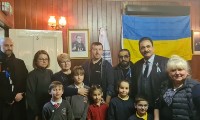 People with Ukrainian flag in the background