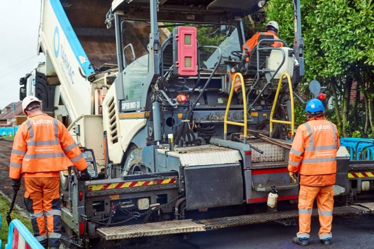 Crew resurfacing road 