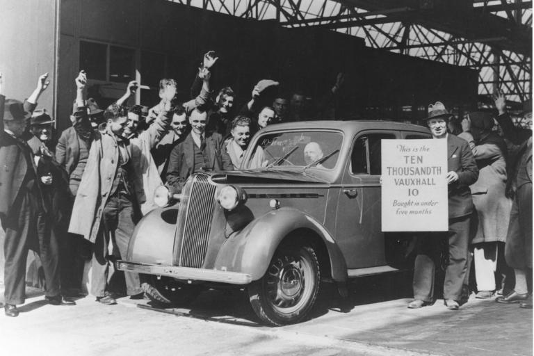 Archival image of Vauxhall staff with car