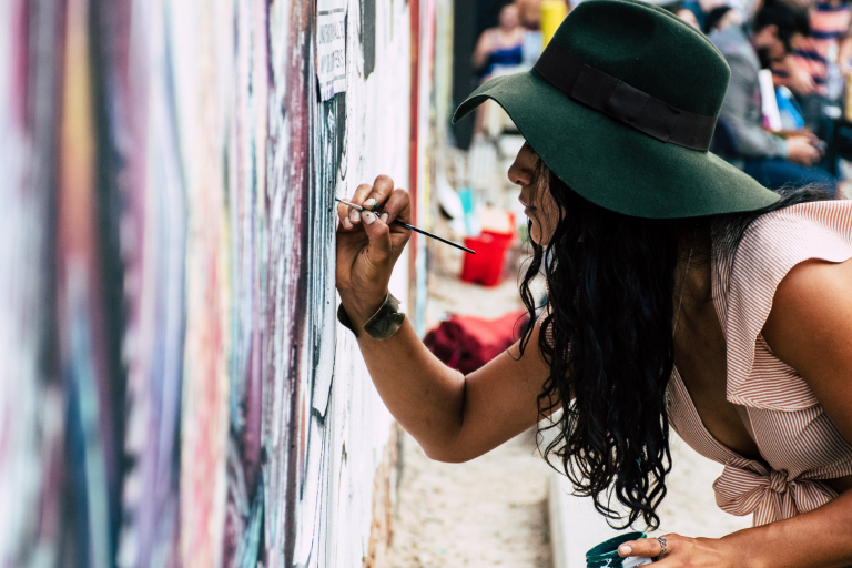 lady painting a building