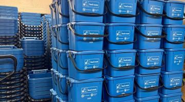 Stacked food waste caddies.