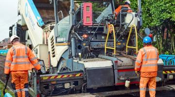 Crew resurfacing road 