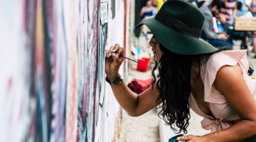 lady painting a building